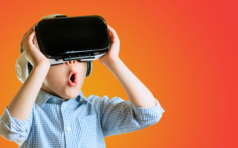 young boy using VR device